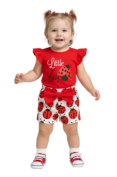 Child wearing a red 'Little Lady' outfit with ladybug pattern on a white background